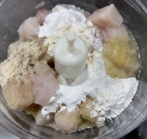 Place the fish in a food processor or blender. Add onion powder, garlic powder, salt, sugar, white pepper, oil, flour, starch, baking powder, and egg white.