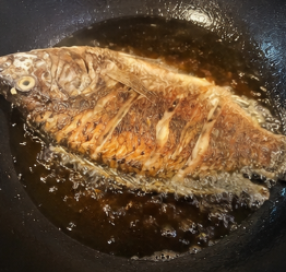 Heat ½ cup cooking oil in a pan. Once hot, fry the fish until golden and crispy on both sides.