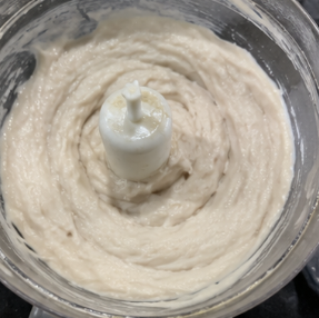 Pulse the mixture for 2 to 3 minutes while gradually adding the ice-cold water. Blend until the mixture becomes smooth, thick, and paste-like.