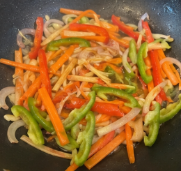 Add the carrots, red bell pepper, and green bell pepper. Cook for 1 to 2 minutes, just until slightly tender but still crisp.