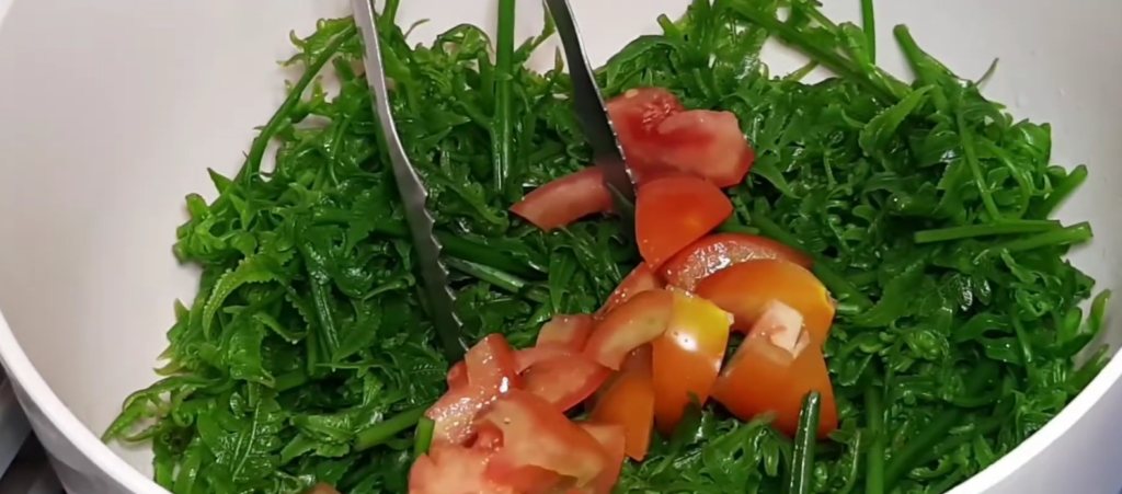 Top with sliced tomatoes, white onions, and salted eggs.