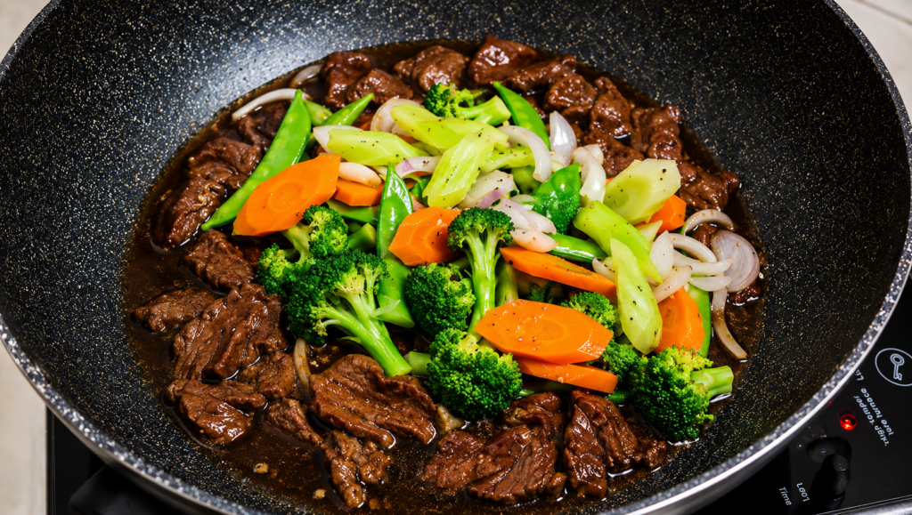 Transfer all the vegetables into the pot with the beef. Add the beef bouillon cubes, ginger, brown sugar, and pepper.