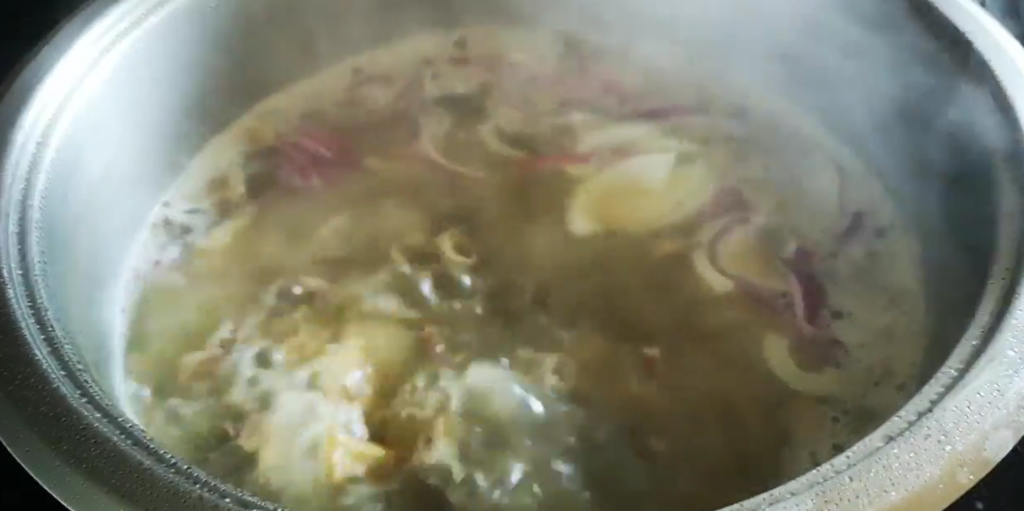 Add the kamias and beef bile or bitter melon. Simmer for another 5 minutes.