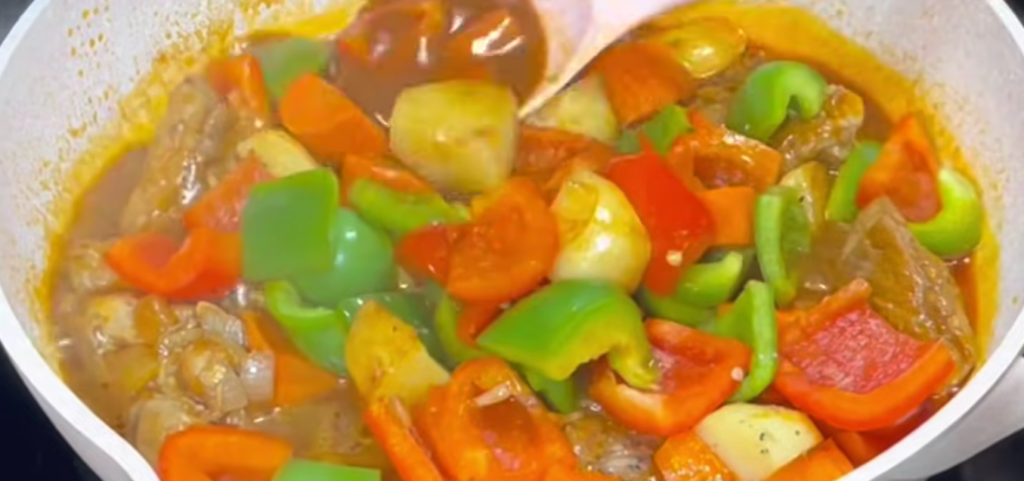 Stir in the sliced bell peppers and grated cheese. Cook for 3 minutes, or until the cheese melts into the sauce.