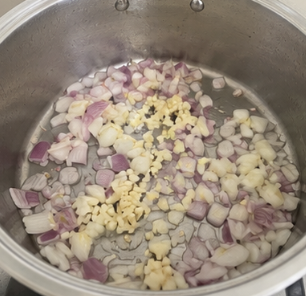 Heat the cooking oil in a large pot over medium heat. Add the onion and garlic and cook until fragrant.