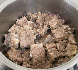 Add the pork spare ribs and cook for about 5 minutes, stirring occasionally, until the meat is lightly browned.