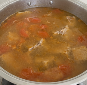 Add the water and bring everything to a boil. Skim off any foam or impurities that rise to the surface.