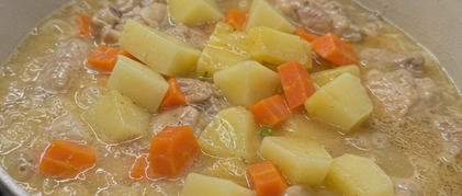 Add the potatoes and carrots. Continue simmering until the vegetables become tender.